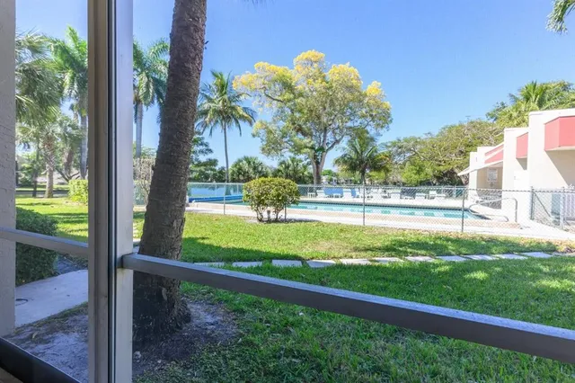 a swimming pool with outdoor seating and yard