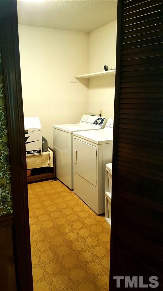 13624 New Light Road Raleigh, NC 27614 - Photo 5 of 12 a bathroom with a sink and a washing machine