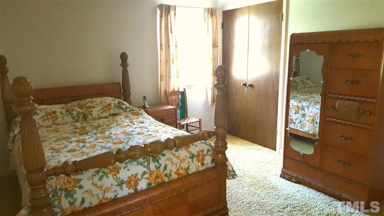 13624 New Light Road Raleigh, NC 27614 - Photo 6 of 12 a bedroom with a bed and wooden floor