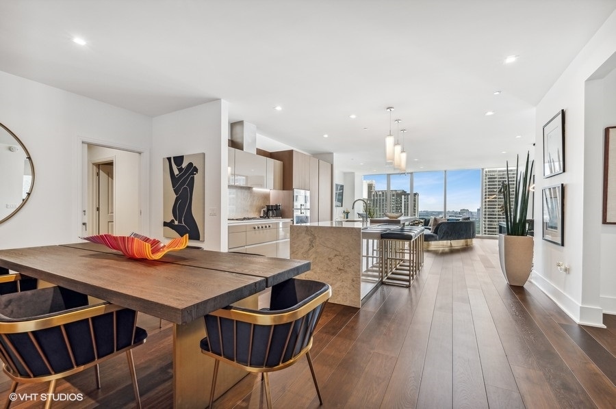 363 East Wacker Drive, Unit 2103 Chicago, IL 60601 - Photo 11 of 19 a view of a dining room kitchen with furniture and wooden floor