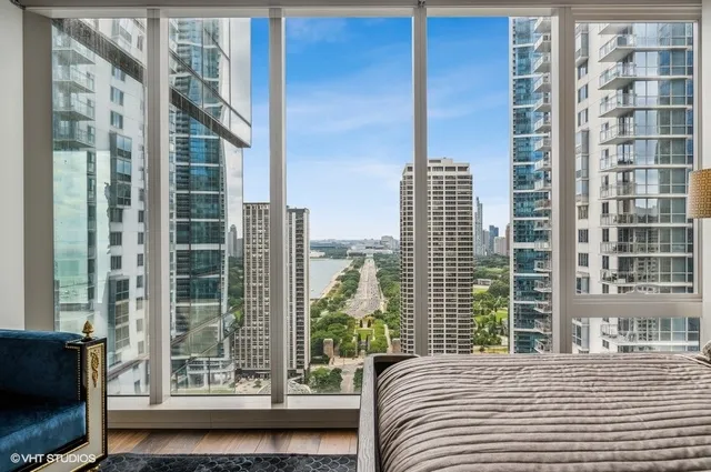 a bathroom with a double vanity sink and mirror with shower