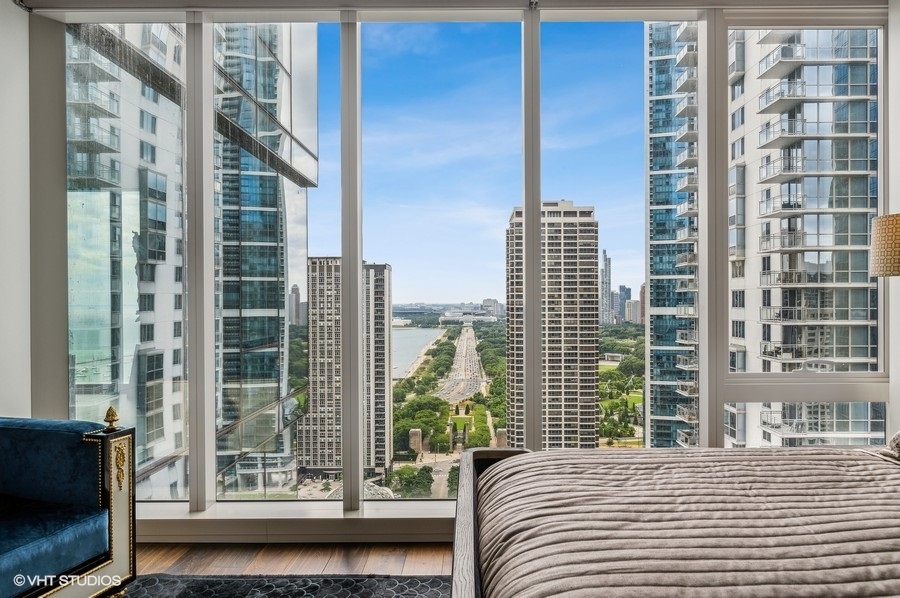 363 East Wacker Drive, Unit 2103 Chicago, IL 60601 - Photo 13 of 19 a bedroom with a bed and a window