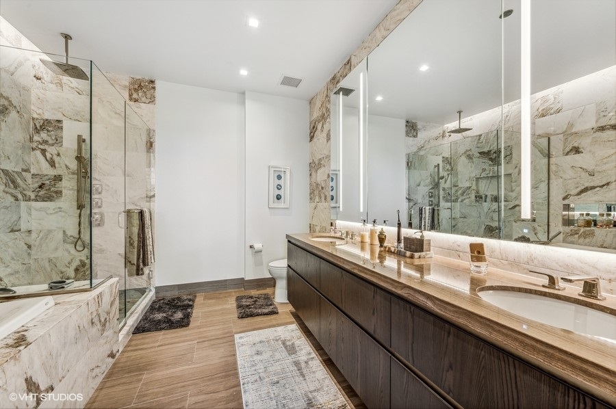 363 East Wacker Drive, Unit 2103 Chicago, IL 60601 - Photo 14 of 19 a bathroom with a double vanity sink and mirror with shower