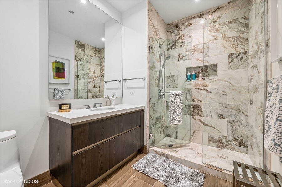 363 East Wacker Drive, Unit 2103 Chicago, IL 60601 - Photo 17 of 19 a bathroom with a sink toilet and shower