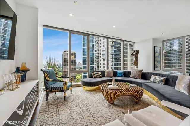a living room with furniture and a floor to ceiling window