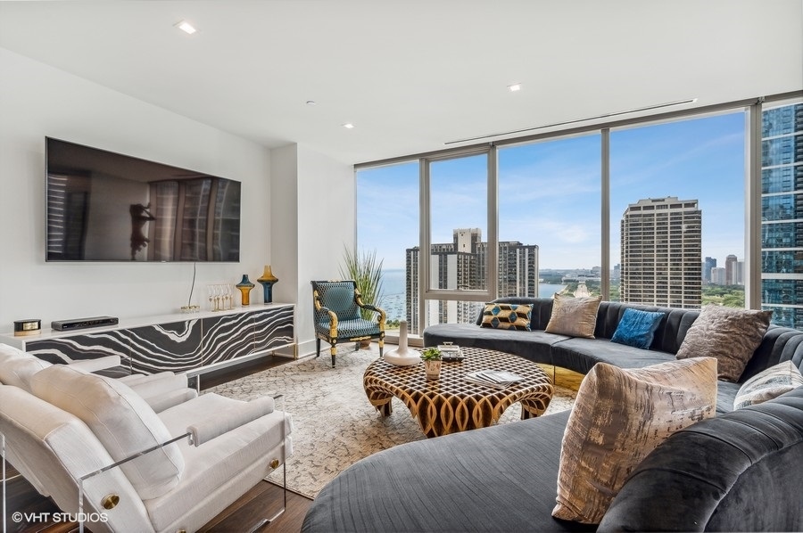363 East Wacker Drive, Unit 2103 Chicago, IL 60601 - Photo 4 of 19 a living room with furniture and a floor to ceiling window