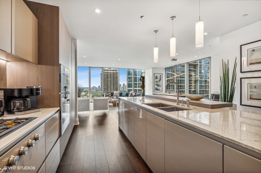 363 East Wacker Drive, Unit 2103 Chicago, IL 60601 - Photo 8 of 19 a large kitchen with a large window and stainless steel appliances