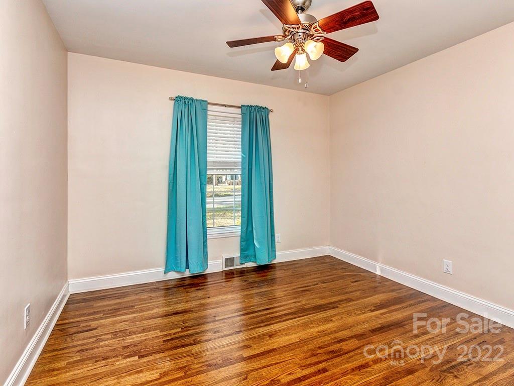 259 North Sharon Amity Road Charlotte, NC 28211 - Photo 19 of 27 an empty room with wooden floor fan and windows