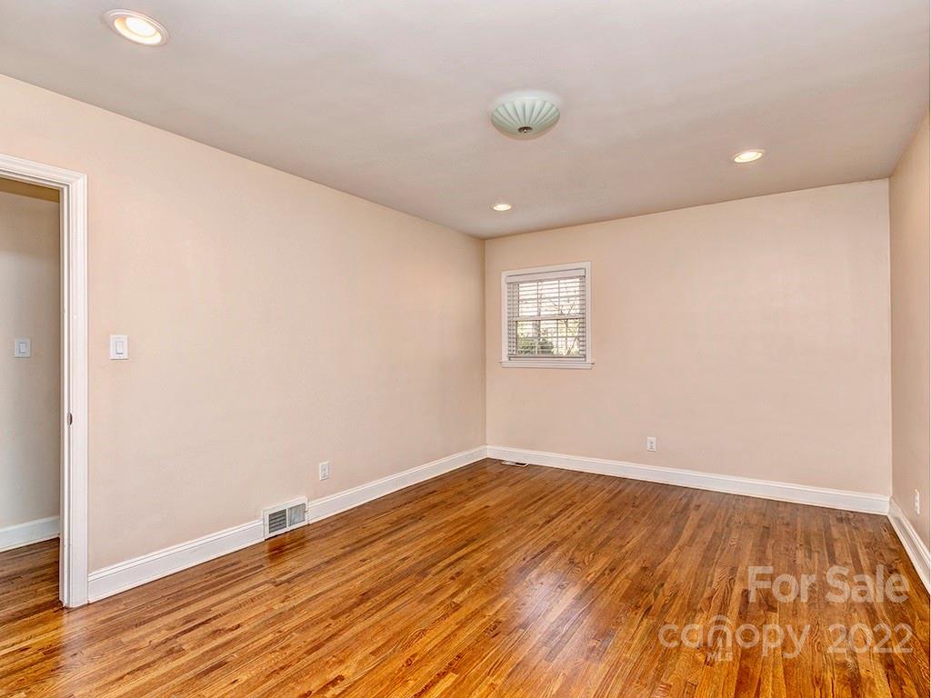 259 North Sharon Amity Road Charlotte, NC 28211 - Photo 21 of 27 an empty room with wooden floor and windows