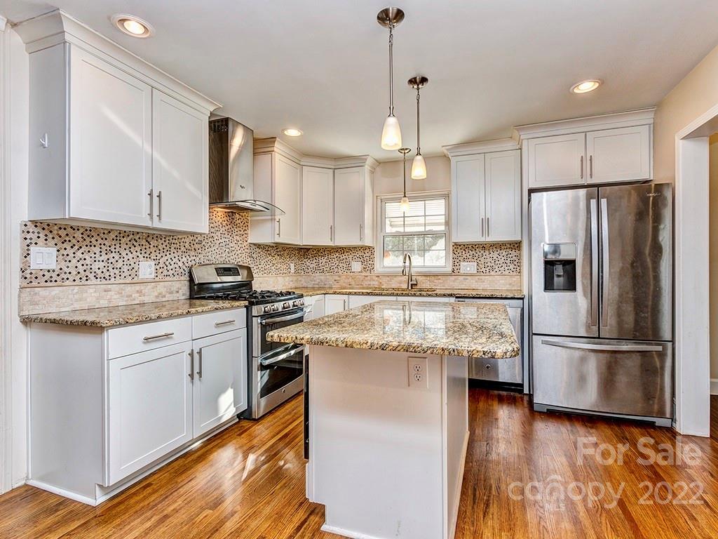 259 North Sharon Amity Road Charlotte, NC 28211 - Photo 9 of 27 a kitchen with stainless steel appliances granite countertop a refrigerator a stove a sink and a microwave