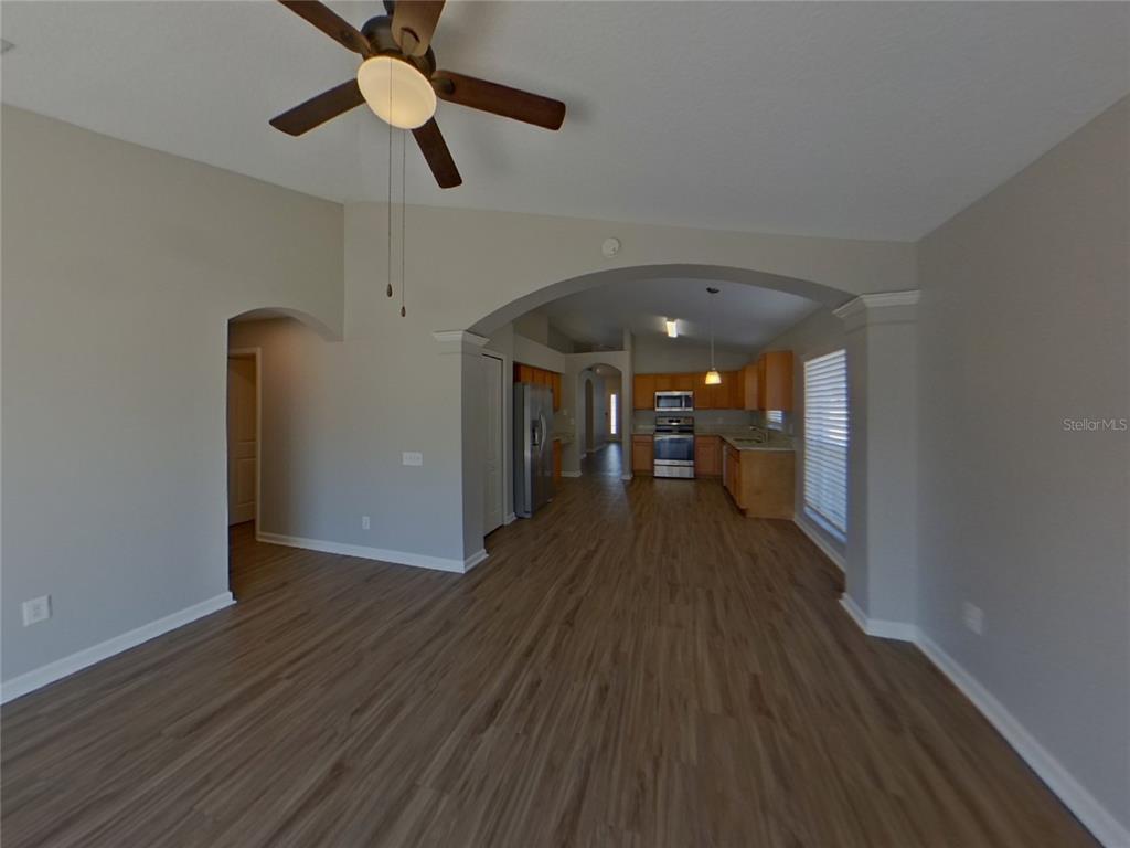 Undisclosed Address Riverview, FL 33579 - Photo 15 of 17 a view of a room with wooden floor a ceiling fan and window