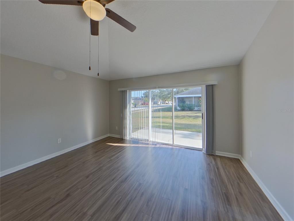 Undisclosed Address Riverview, FL 33579 - Photo 16 of 17 a view of an empty room with wooden floor and a window
