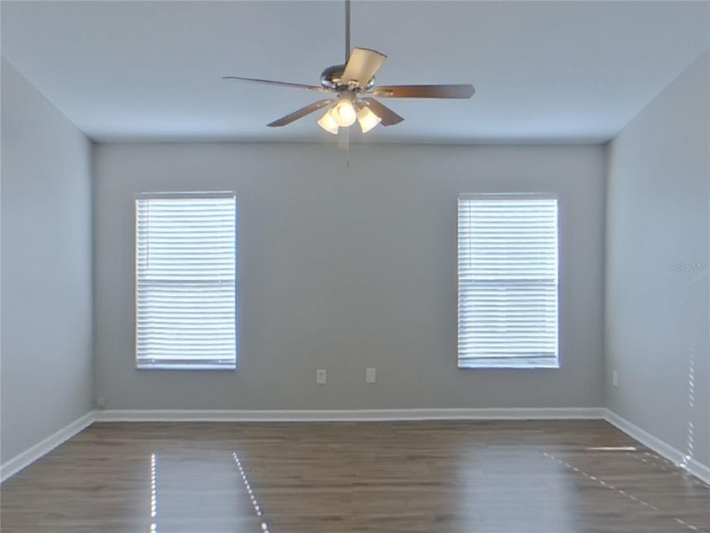 Undisclosed Address Riverview, FL 33579 - Photo 6 of 17 a view of an empty room with wooden floor and a window