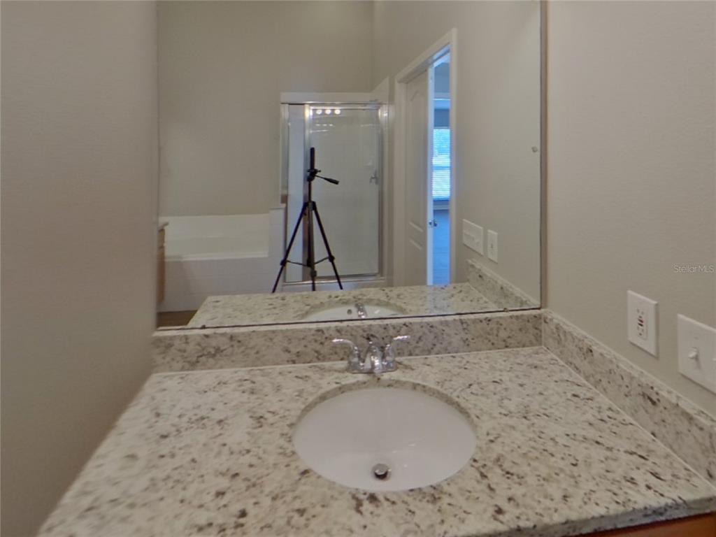 Undisclosed Address Riverview, FL 33579 - Photo 8 of 17 a bathroom with a granite countertop sink and a mirror