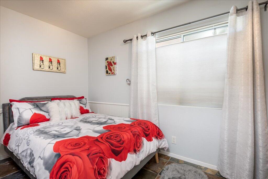 800 East Cottonwood Road, Unit 2 Palm Springs, CA 92262 - Photo 14 of 29 a bedroom with a bed and a painting on the wall