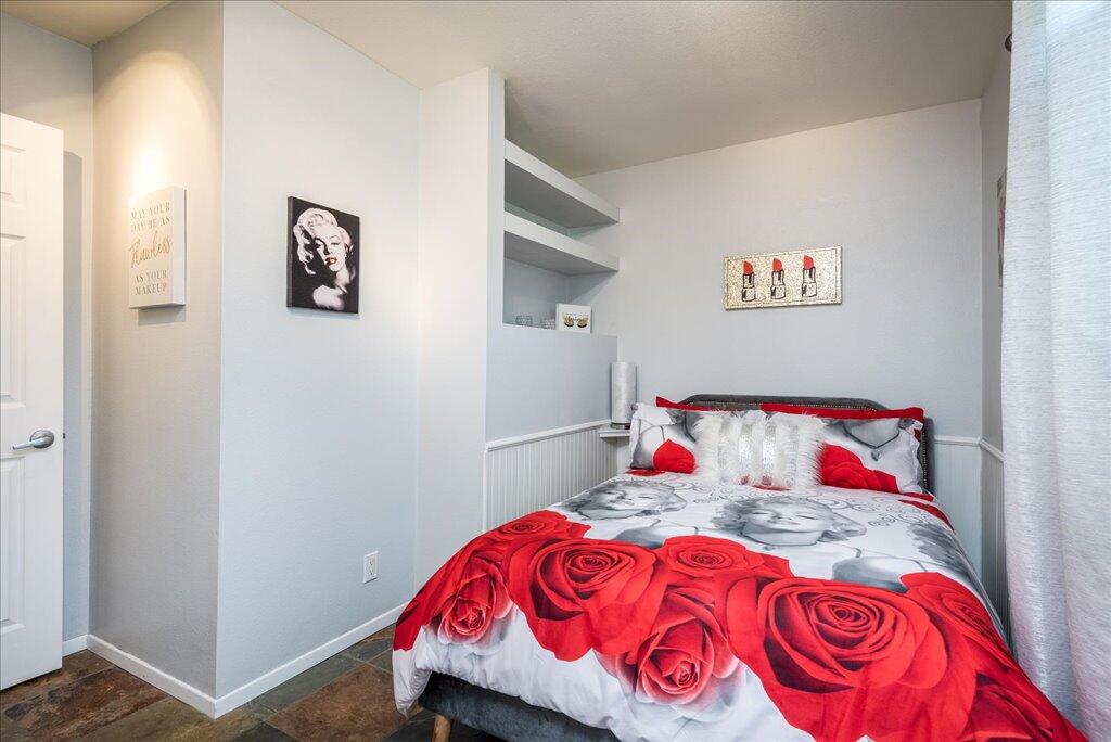 800 East Cottonwood Road, Unit 2 Palm Springs, CA 92262 - Photo 16 of 29 a bedroom with a bed and a painting on the wall