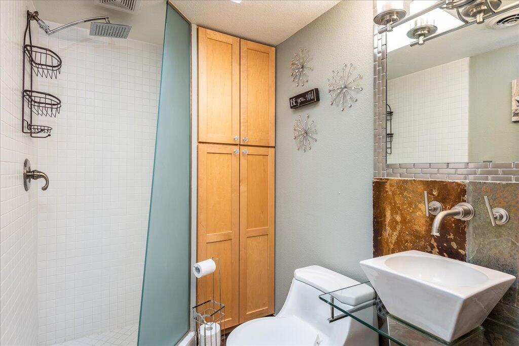 800 East Cottonwood Road, Unit 2 Palm Springs, CA 92262 - Photo 17 of 29 a white toilet sitting next to a bathroom sink