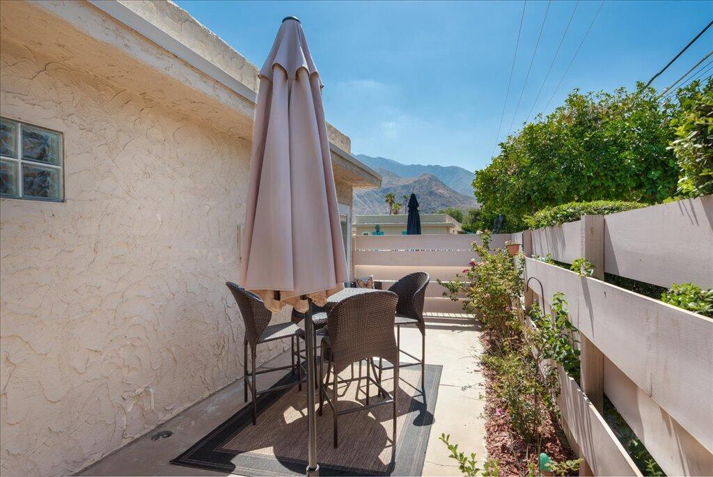 800 East Cottonwood Road, Unit 2 Palm Springs, CA 92262 - Photo 19 of 29 a view of a patio with table and chairs and potted plants