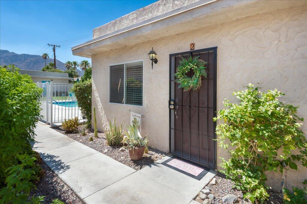 800 East Cottonwood Road, Unit 2 Palm Springs, CA 92262 - Photo 3 of 29 front view of a house with potted plants