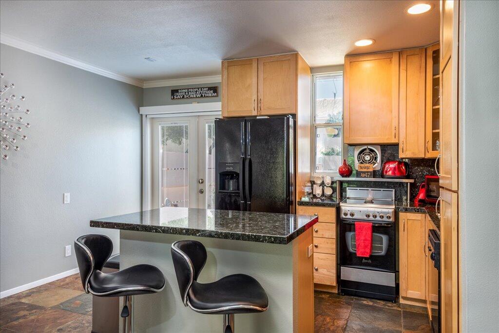 800 East Cottonwood Road, Unit 2 Palm Springs, CA 92262 - Photo 6 of 29 a kitchen with stainless steel appliances granite countertop a refrigerator and a stove