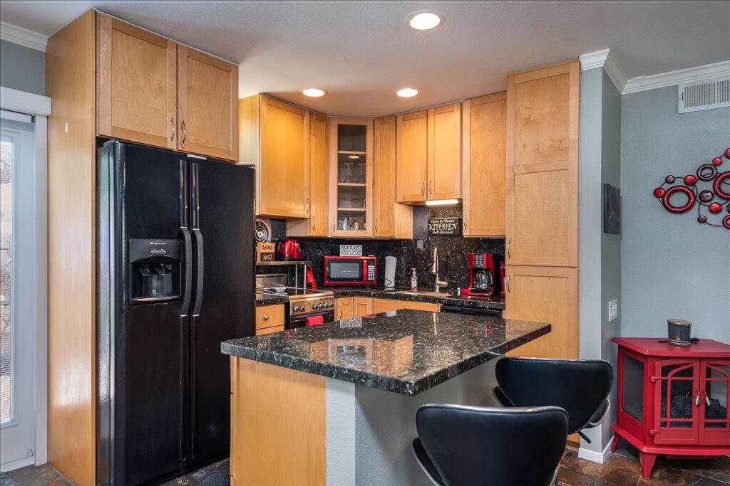 800 East Cottonwood Road, Unit 2 Palm Springs, CA 92262 - Photo 7 of 29 a kitchen with stainless steel appliances granite countertop a refrigerator and a stove