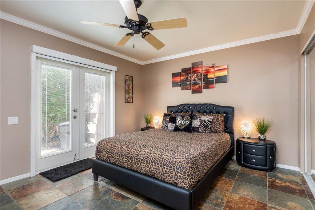 800 East Cottonwood Road, Unit 2 Palm Springs, CA 92262 - Photo 8 of 29 a bedroom with a bed and a ceiling fan