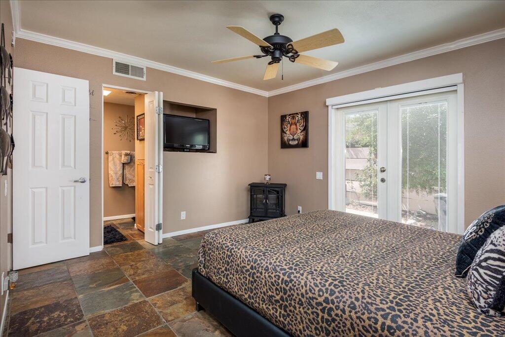 800 East Cottonwood Road, Unit 2 Palm Springs, CA 92262 - Photo 9 of 29 a spacious bedroom with a large bed a flat screen tv and balcony