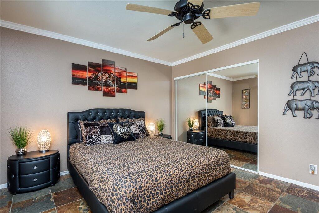 800 East Cottonwood Road, Unit 2 Palm Springs, CA 92262 - Photo 10 of 29 a bedroom with a bed and a chandelier