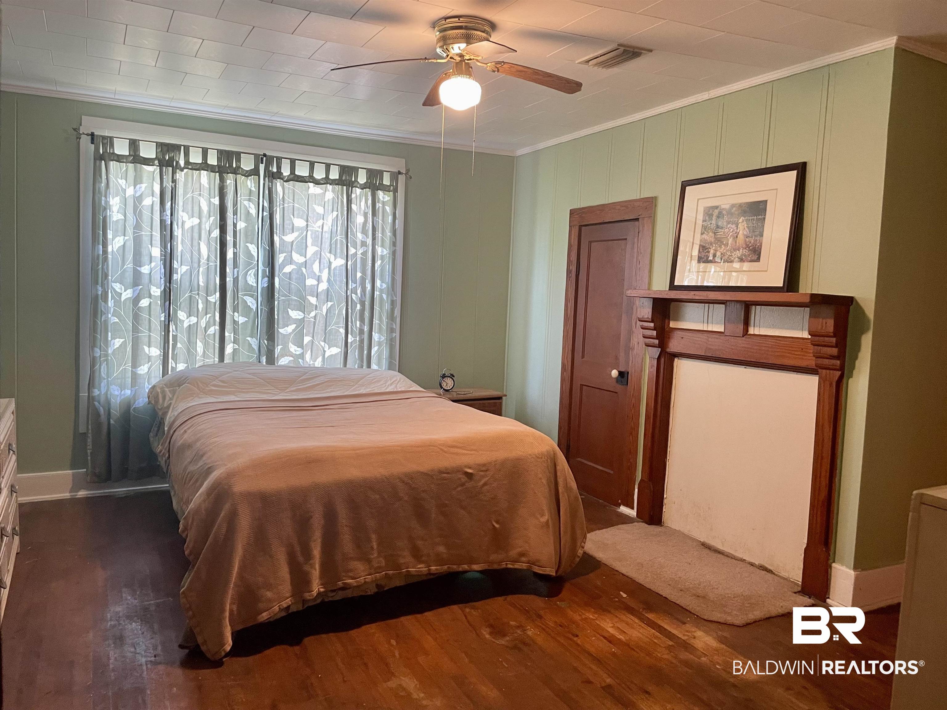 10673 Jack Springs Road Atmore, AL 36502 - Photo 11 of 14 Bedroom with ceiling fan, dark hardwood / wood-style flooring, and ornamental molding