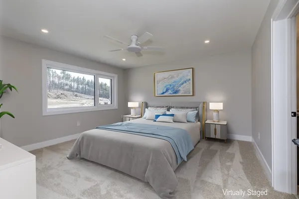 a bedroom with a large bed and a window