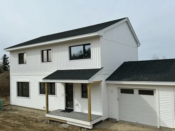 a front view of a house with garage