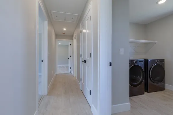 a view of a hallway with washer and dryer