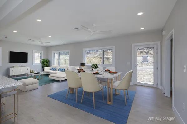 a view of a dining room with furniture and wooden floor
