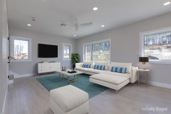 a living room with furniture and a flat screen tv