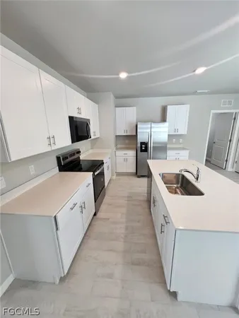 a kitchen with kitchen island granite countertop lots of counter top space and stainless steel appliances