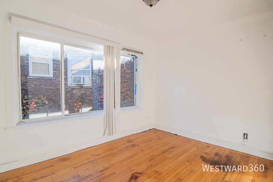 7833 South Kingston Avenue, Unit 2 Chicago, IL 60649 - Photo 11 of 15 a view of empty room with wooden floor and fan