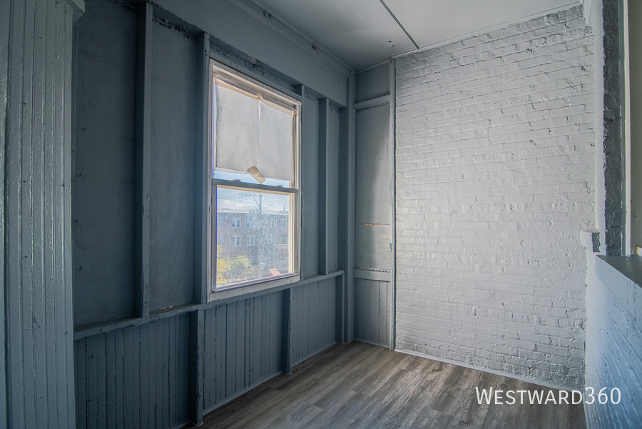 7833 South Kingston Avenue, Unit 2 Chicago, IL 60649 - Photo 15 of 15 a view of an empty room with wooden floor and a window