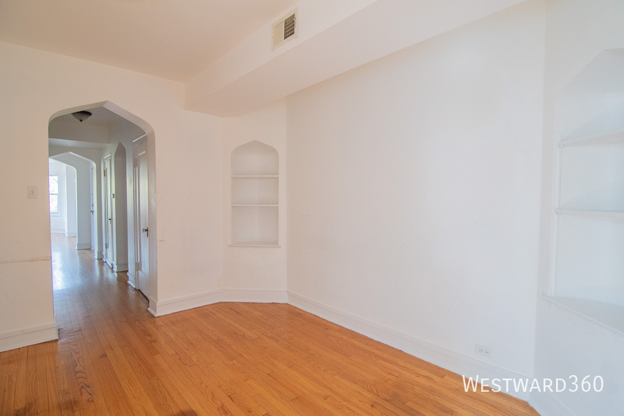7833 South Kingston Avenue, Unit 2 Chicago, IL 60649 - Photo 8 of 15 a view of a room with wooden floor and a hallway