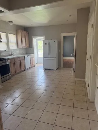 a view of a kitchen with a sink and cabinets