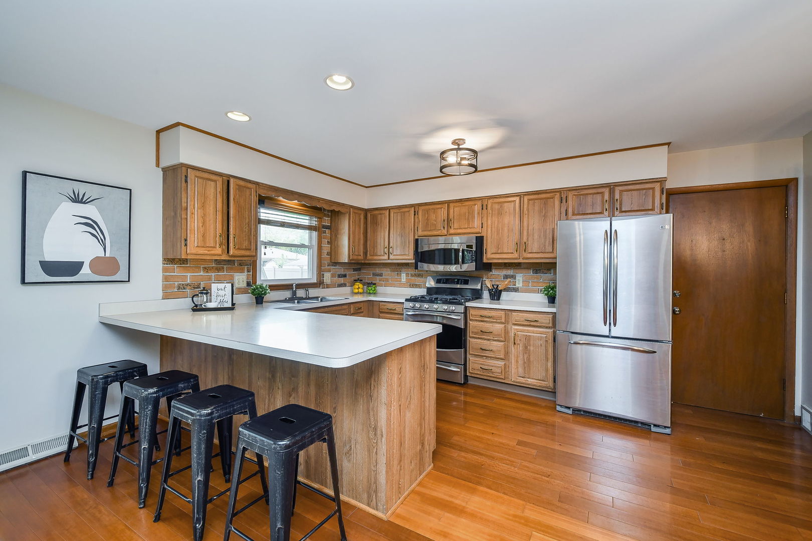 1920 Richard Street Aurora, IL 60506 - Photo 11 of 23 a kitchen with refrigerator cabinets and wooden floor