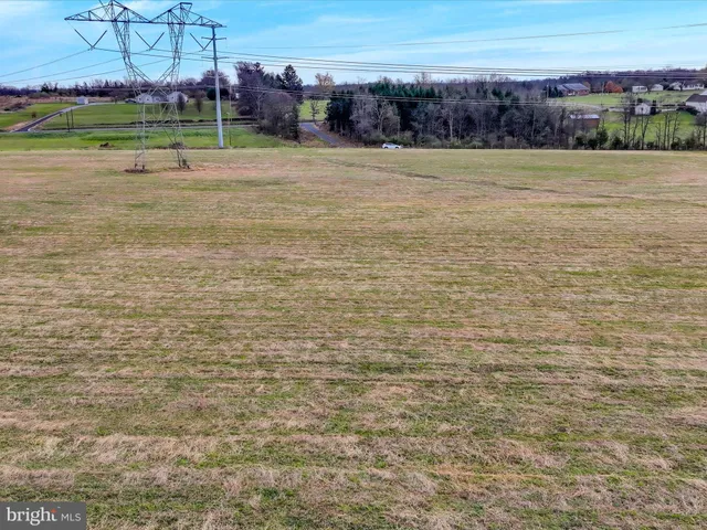 a view of a field with an ocean