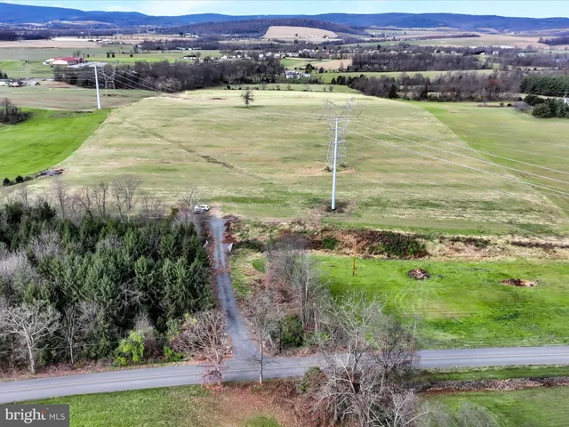 a view of a field with an ocean