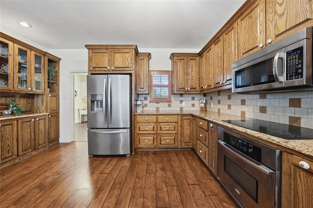 5262 Rio Vista Malakoff, TX 75148 - Photo 13 of 29 a kitchen with stainless steel appliances granite countertop a refrigerator microwave and sink