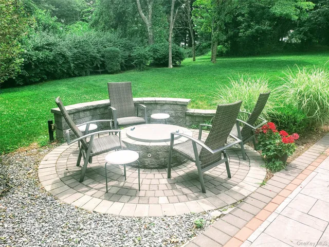 a view of a house with backyard sitting area and garden