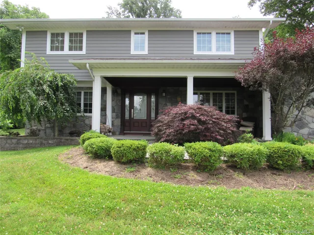 a view of a house with a yard and plants