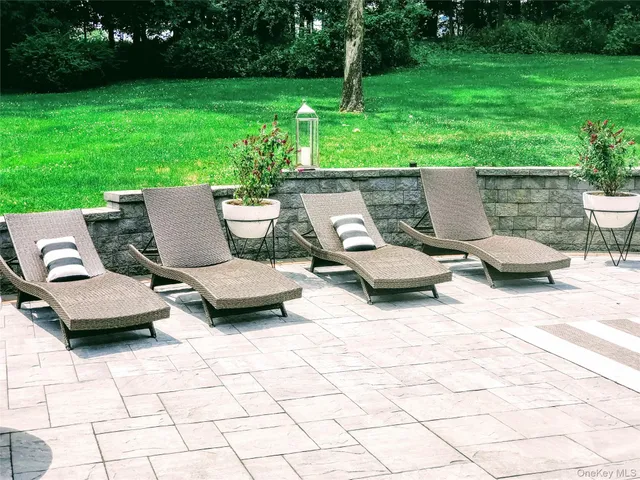 a view of a patio with garden and furniture