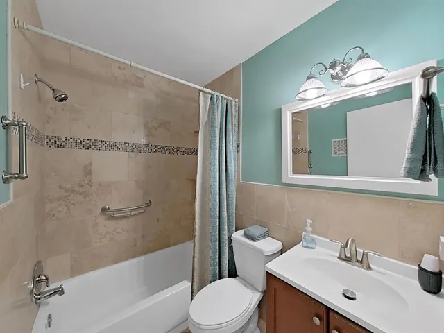 a view of living room kitchen and entryway