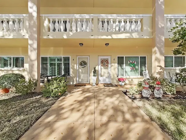 a front view of a building with flowers
