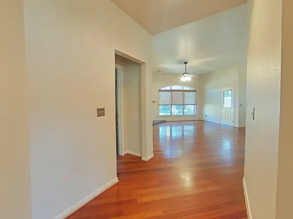 a view of livingroom with hardwood floor and a hallway