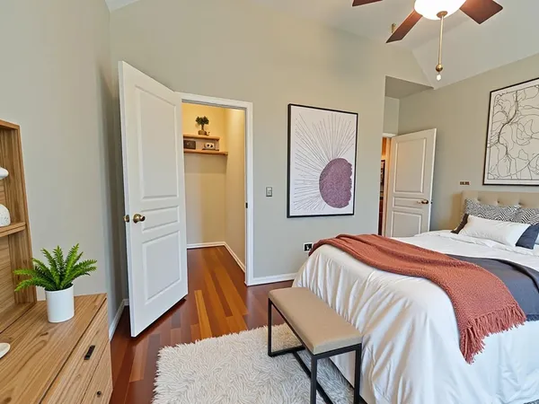 a bedroom with a bed and wooden floor